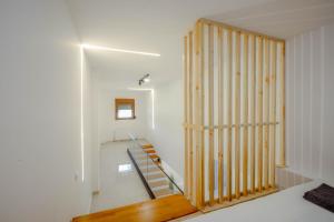 a staircase in a house with a wooden door at Oasis Acropolis Serres With Parking Next to Center in Serres