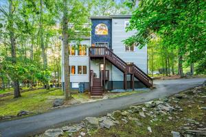 a house with a staircase in front of it at Sleeps 14 Hot Tub Paddle Boards Arcade Games in East Stroudsburg