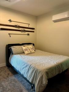 a bedroom with a bed with a pillow on it at Modern 2BR Retreat in Harbor in Harbor Springs