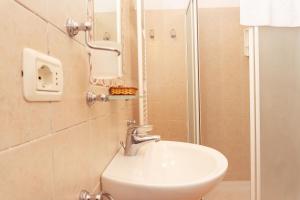 a bathroom with a sink and a shower at Filippo in Rapale
