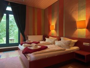a bedroom with a large bed with a striped wall at Gruppenhaus in Buntenbock in Buntenbock