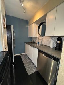 a kitchen with white cabinets and a stainless steel refrigerator at 5 STATE FAIR l DT Dallas l FIFA READY l Staycation 1Bd1Ba in Dallas