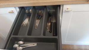 a drawer in a kitchen with utensils at Apartament Motyl in Warsaw +3 photos
