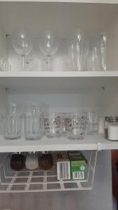 a shelf filled with glasses and other items in a refrigerator at Apartament Motyl in Warsaw