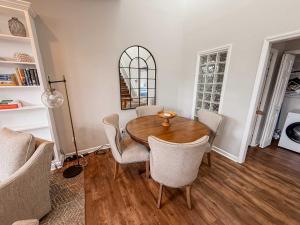 a dining room with a wooden table and chairs at Downtown Condo - 2BR 2BA Walk to Everything in Raleigh
