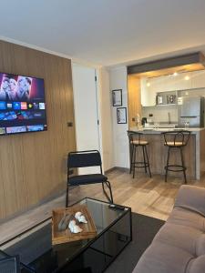 a living room with a couch and a table at NM Departamentos Amoblados in Concepción +34 photos