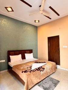 um quarto com uma cama e um ventilador de teto em Raghav dham em Vrindāvan