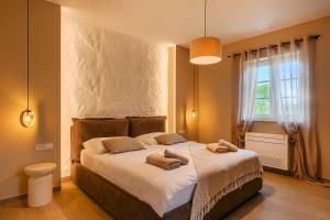 a bedroom with a large bed with two towels on it at Villa Bel Fiore in Sveti Lovreč Pazenatički +42 photos