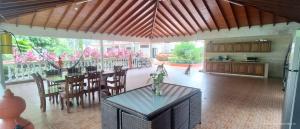 a large kitchen and dining room with a table and chairs at Hotel Villa De Los Angeles in Villavicencio