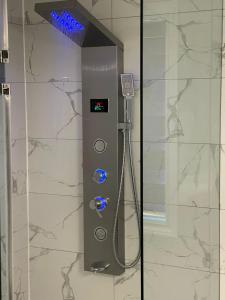 a shower in a bathroom with aperature at Grandeur Homes in Whitby
