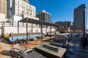 a patio with benches and tables in a city at OTR Gym Pool Free parking walk to stadiums in Cincinnati