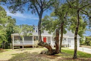 a white house with a red door and trees at Spencer's Villa in Frisco
