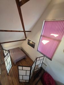 an overhead view of a room with a bed and a window at Historic Canal-Side Apartment in Schiedam