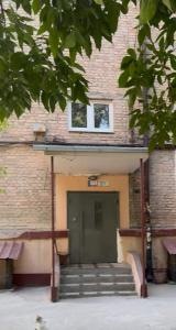 a building with a door and stairs in front of it at Laylak House in Salor Bekati