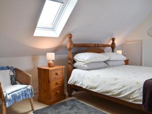 a bedroom with a bed and a skylight at Tradewinds in Portknockie +8 photos