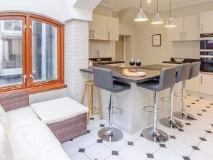 a kitchen with a couch and a table with chairs at Blair Terrace in Portpatrick