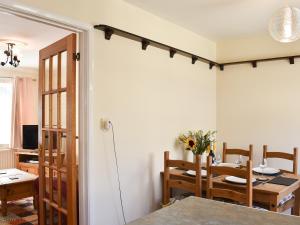 a dining room with a table and a room with a dining room at Twizell Cottage in Alnwick