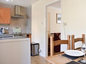 a kitchen and dining room with a table and chairs at Twizell Cottage in Alnwick
