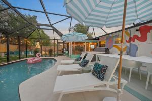 a pool with white tables and chairs and a pink swan at Heated Pool, Mini Golf, Arcade, Spa, AMI 6mi, IMG 3mi in Bradenton