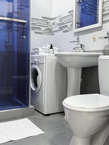 a bathroom with a washing machine and a sink at Laylak House in Salor Bekati