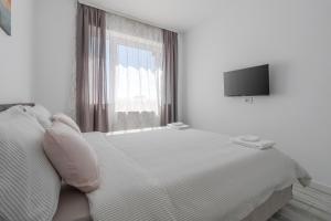 Ένα ή περισσότερα κρεβάτια σε δωμάτιο στο Home Guest - Apartment 9