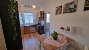 a small kitchen and dining room with a table with a plant at Ferienwohnung Bauer in Graz