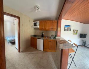 a small kitchen with wooden cabinets and a table at Casa Colonia in Mogán