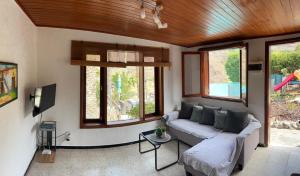a living room with a couch and some windows at Casa Colonia in Mogán