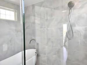a bathroom with a shower with a shower head at Water Street Retreat in Chelan