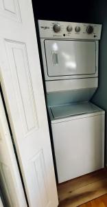 a small white stove in a kitchen next to a door at Water Street Retreat in Chelan +12 photos