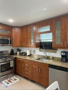 a kitchen with wooden cabinets and a sink at Remodeled Townhouse in Watertown in Watertown