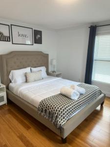 a bed with two pillows on it in a bedroom at Remodeled Townhouse in Watertown in Watertown +9 photos