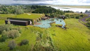 an aerial view of a building on a grassy hill at Enchanting country home in Laugaras +21 photos