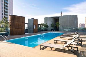 a swimming pool on the roof of a building at Spot Suites in Santiago