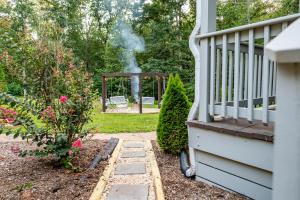 a house with a garden with smoke coming out the backdoor at Pickleball - Sleeps 14 - 151 Brew Trail - Firepit in Nellysford