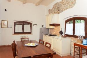 a kitchen with a wooden table and a dining room at Giovanni in Rapale