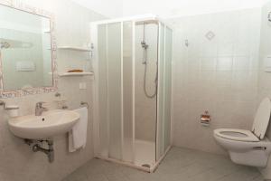 a bathroom with a shower and a toilet and a sink at Giovanni in Rapale
