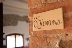 a sign on a brick wall with the word abnormal at Giovanni in Rapale +33 photos