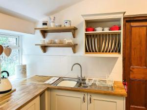 a kitchen with a sink and a counter at Blue House Cottage in Elsdon