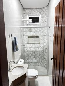 een badkamer met een toilet, een wastafel en een douche bij Studio Bougainville Apart in Conceição do Mato Dentro +6 foto's