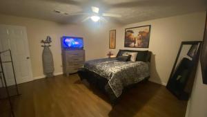 a bedroom with a bed and a dresser and a ceiling fan at Your Private 1-Bedroom Guest House in College Park in College Park