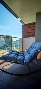 a group of blue pillows sitting in a room with a large window at Apartament na Mazurach in Ełk +13 photos