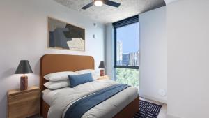 a bedroom with a bed and a large window at Sentral Sol Modern in Phoenix +22 photos