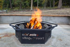 a fire in a container with flames in it at Chalet Haesler Jr - Edelweiss Village in Golden
