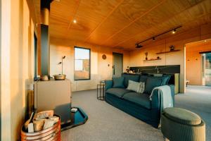 a living room with a blue couch in a room at Beresford Heights & Rise in Maclennan