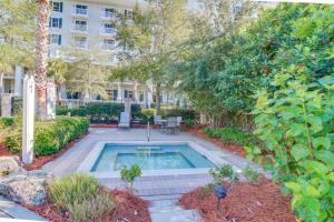 a swimming pool in a yard with a building at Bahia #4110 in Destin