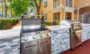 a kitchen with a grill and a stove at Mizner Place at Weston Town Center, Fort Lauderdale in Weston