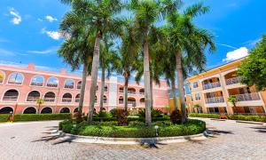a group of palm trees in front of a building at Mizner Place at Weston Town Center, Fort Lauderdale in Weston