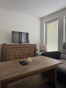 a living room with a coffee table and a tv at Privat vila 303 in Martin