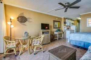 a bedroom with a bed and a table with a dining room at Harbour Beach Resort 408 in Daytona Beach
